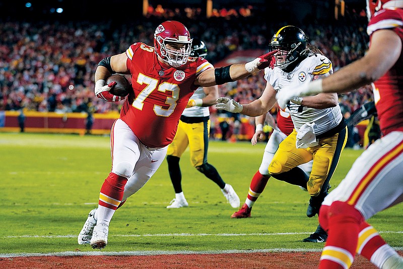 Chiefs guard Nick Allegretti scores on a 1-yard touchdown reception during the second half of Sunday night’s AFC wild-card playoff game against the Steelers at Arrowhead Stadium. (Associated Press)