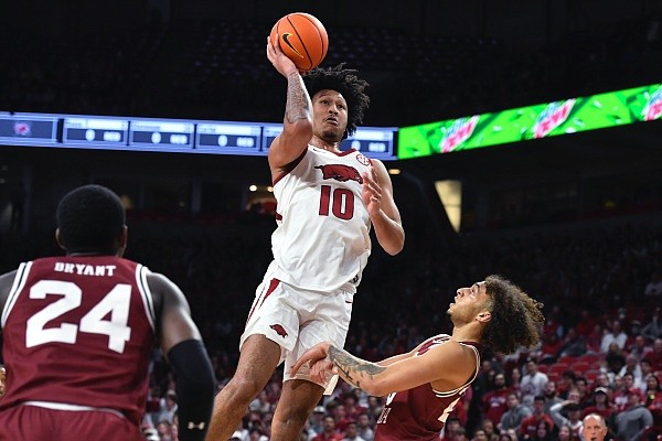 Arkansas forward Jaylin Williams (10) shoots over South Carolina guard Devin Carter (23) during the first half of an NCAA college basketball game Tuesday, Jan. 18, 2022, in Fayetteville. (AP Photo/Michael Woods)