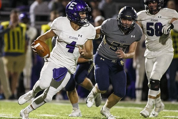 Elkins quarterback Braedon Welch (4) is pressured by Shiloh Christian linebacker JT Odom (33) during a game Friday, Oct. 22, 2021, in Springdale.