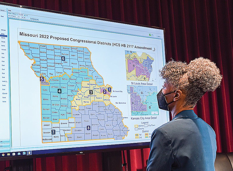 State Rep. Yolanda Young, D-Kansas City, studies one of the redistricting maps during debate Tuesday in the Missouri House of Representatives. Numerous meetings and hearings were held over the summer to come up with proposals to suit legislators. (Julie Smith/News Tribune photo)