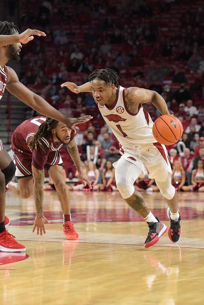 JD Notae (1), senior guard for the Arkansas Razorbacks, drives as James Reese V of South Carolina defends on Tuesday, Jan. 18, 2022, during the second half of the Razorbacks' 75-59 win over the Gamecocks at Bud Walton Arena in Fayetteville. Visit nwaonline.com/220119Daily/ for today's photo gallery..(NWA Democrat-Gazette/Hank Layton)