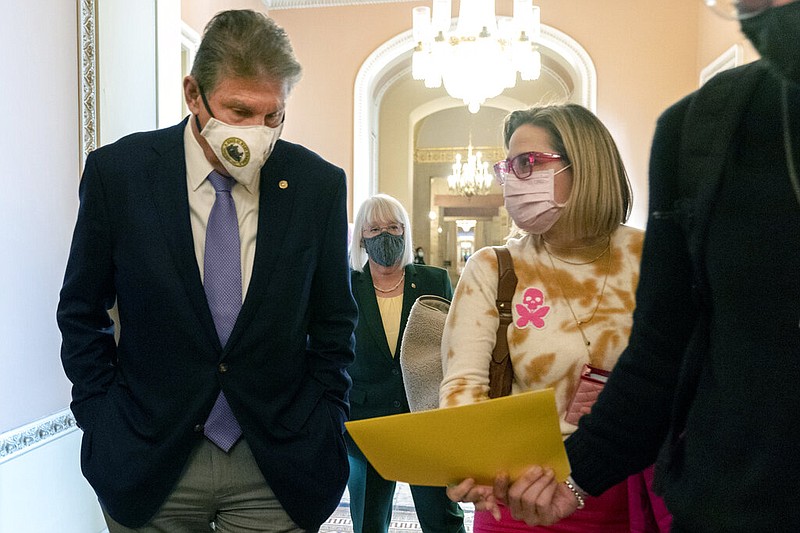 Sen. Joe Manchin (left), D-W.Va., walks with Sen. Kyrsten Sinema, D-Ariz., after attending a Democratic policy luncheon on Capitol Hill in Washington in this Nov. 16, 2021, file photo. Walking behind them is Sen. Patty Murray, D-Wash. (AP/Jacquelyn Martin)