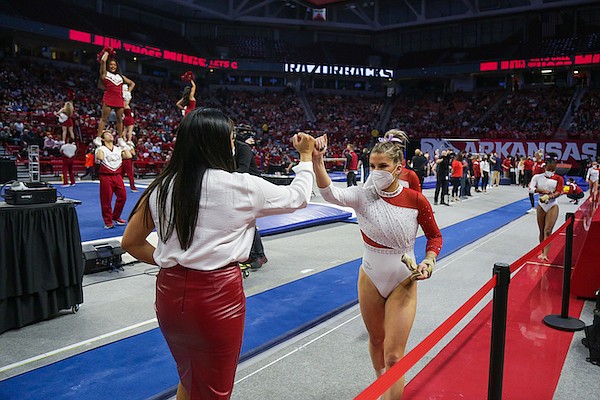 Arkansas gymnast Cami Weaver (right) is shown during a meet against Auburn on Friday, Jan. 14, 2022, in Fayetteville.