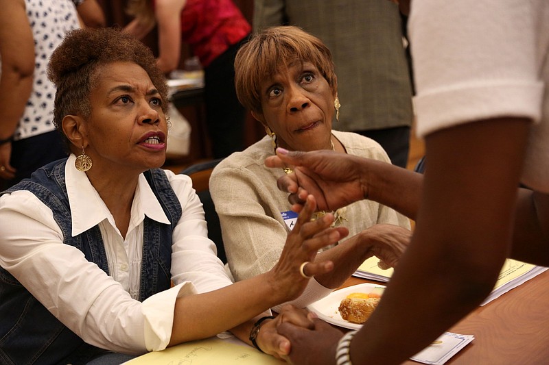 Loretta Hendrix (left) and her mother, Little Rock Ward 1 City Director Erma Hendrix, speak with Debbie Priebe during an event at the Hinton Resource Center in Little Rock in this June 8, 2013, file photo. Erma Hendrix died in September 2021. (Arkansas Democrat-Gazette file photo)