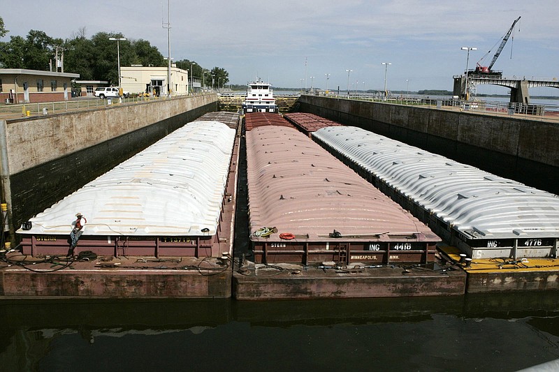 A towboat and its barges are shown in the channel at Winfield Lock and Dam near Winfield, Mo., on the Mississippi River. The U.S. Army Corps of Engineers announced it will spend $732 million to expand infrastructure to help barges more efficiently transport goods.
(AP)