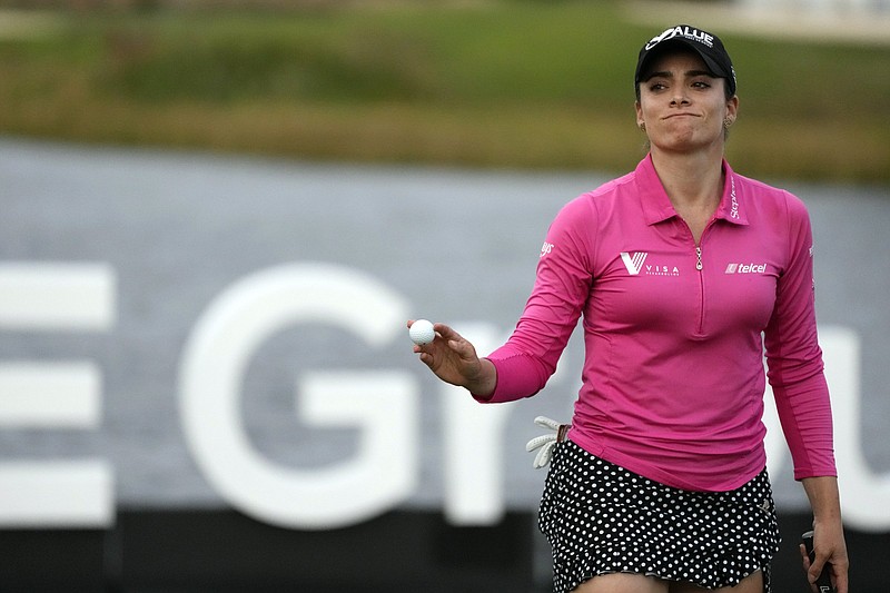 Gaby Lopez, of Mexico, reacts as she picks up her ball after finishing the 18th hole during the third round of the LPGA Tour Championship golf tournament, Saturday, Nov. 20, 2021, in Naples, Fla. (AP Photo/Rebecca Blackwell)