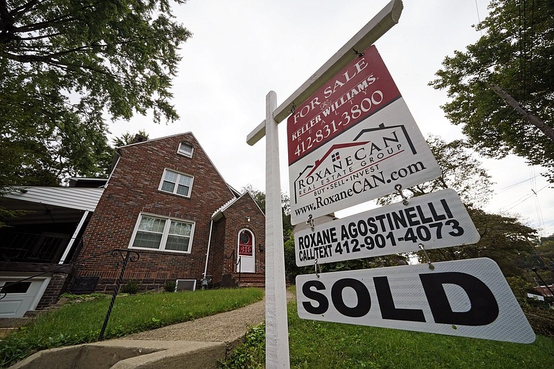 A sign marks a sold house in Mount Lebanon, Pa., in September. Sales of previously owned homes fell in December for the first time in months as mortgage rates ticked higher and potential buyers struggled to find suitable properties in a tight market.
(AP/Gene J. Puskar)