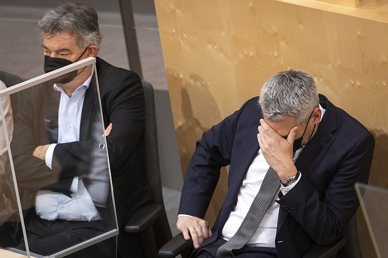 Austrian Vice Chancellor Werner Kogler (left) and Chancellor Karl Nehammer attend a parliamentary session Thursday in Vienna as lawmakers approve a vaccine mandate for adults.
(AP/Lisa Leutner)