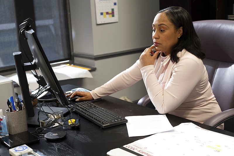 Fulton County, Ga., District Attorney Fani Willis is shown in her office in this Jan. 4, 2022 file photo. The prosecutor is weighing whether Donald Trump and others committed crimes by trying to pressure Georgia officials to overturn Joe Biden’s presidential election victory. (AP/Ben Gray)