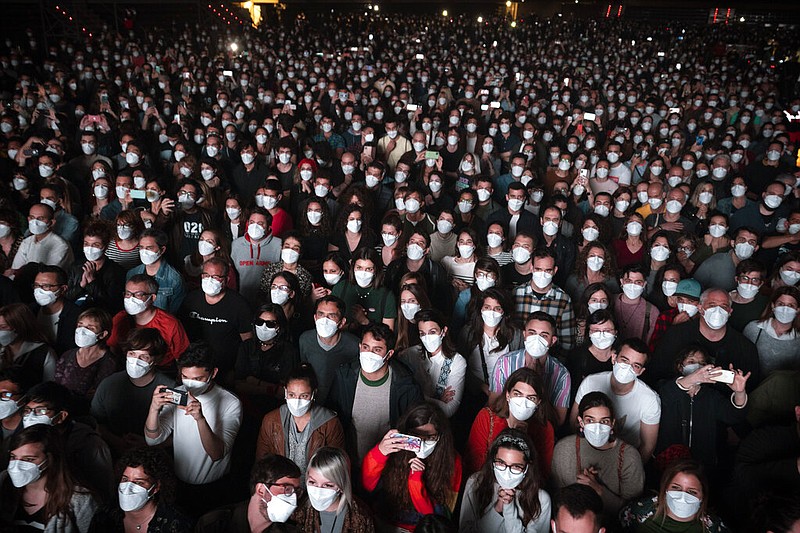 FILE - People using face masks attend a music concert in Barcelona, Spain, March 27, 2021. (AP/Emilio Morenatti, File)