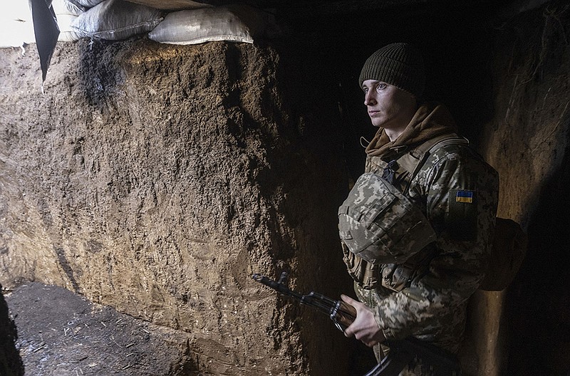 A Ukrainian soldier keeps watch Thursday in a trench on the line of separation from pro-Russian rebels in Mariupol in Ukraine’s Donetsk region. Russia has positioned an estimated 100,000 troops near its border with Ukraine.
(AP/Andriy Dubchak)