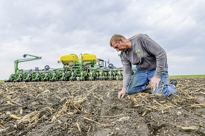 Jeff Frank looks at the soil in 2018 on his farm near Auburn, Iowa. Median home prices, for previously-owned homes, rose by 15.8% in the U.S. last year, but farmland values went up about double that rate in places like Iowa.
(AP File/Iowa Soybean Association/Joseph L. Murphy)