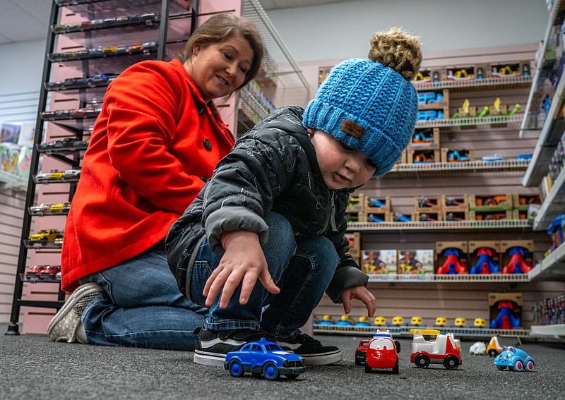 Angie Glenn, left, and her grandson, Lukas Zoellner, 2, shop for toys on Friday at Downtown Book & Toy in Jefferson City. (Ethan Weston/News Tribune)