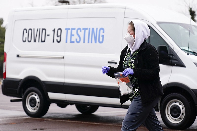 A health care worker walks over to a motorist on Thursday to administer a free drive-thru covid-19 test at a newly opened site in the parking lot of the Mercy Fitzgerald Hospital in Darby, Pa. Approximately 8.8 million workers did not work between a two-week stretch at the start of 2022 because they were either sick with the coronavirus or taking care of someone who was, Census Bureau data show.
(AP/Matt Rourke)