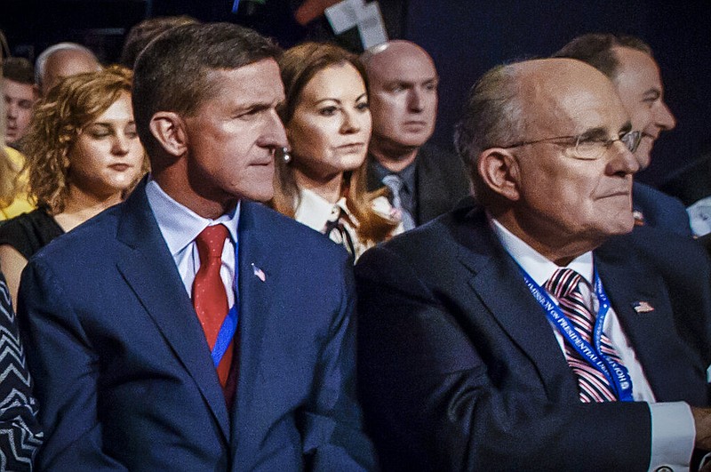 Former Defense Intelligence Agency Director Michael Flynn (left) and former New York Mayor Rudy Giuliani (right) wait for the start of the first presidential debate between Republican candidate Donald Trump and Democratic candidate Hillary Clinton at Hofstra University in Hempstead, N.Y., in this Sept. 26, 2016, file photo. (AP/Evan Vucci)