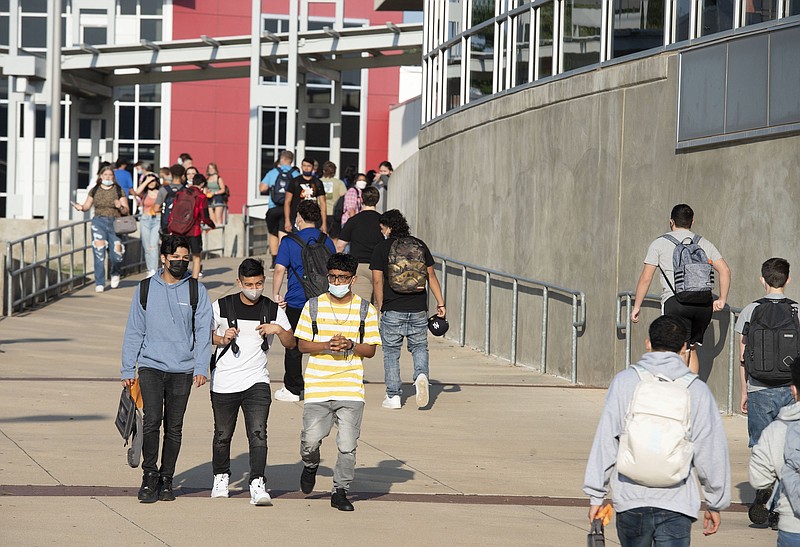 Students wearing masks go to class at the Rogers Heritage High School in this Aug. 16, 2021, file photo. The Rogers School District was requiring masks for students, staff, faculty and visitors for 30 days. (NWA Democrat-Gazette/J.T. Wampler)