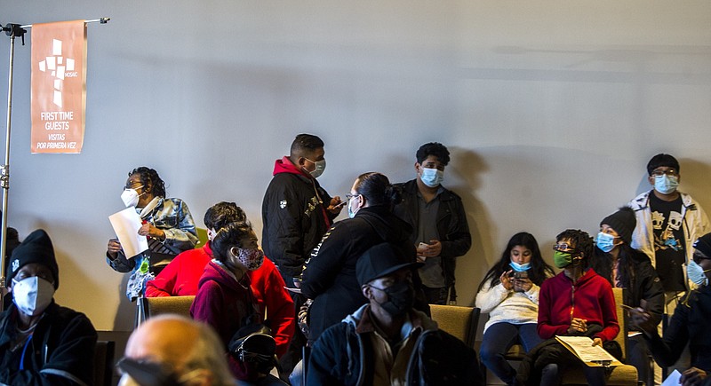 People wait their turn to get covid-19 shots Saturday, Jan. 22, 2022, during a vaccination clinic at the Mosaic Church on Colonel Glenn Road in Little Rock. A line had formed well before the clinic started. (Arkansas Democrat-Gazette/Stephen Swofford)