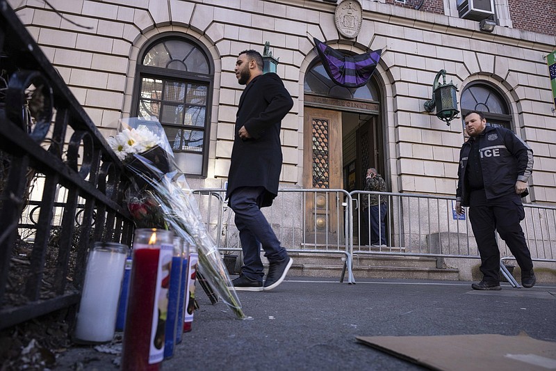 A makeshift memorial is seen outside the New York Police Department 32nd Precinct near the scene of shooting in Harlem on Saturday in New York.
(AP/Yuki Iwamura)