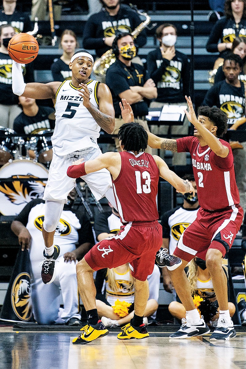 Missouri’s Jarron Coleman saves the ball from going out of bounds in front of Alabama teammates Jahvon Quinerly (center) and Darius Miles during a game earlier this month at Mizzou Arena. (Associated Press)