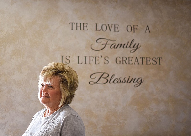 Margaret Schaefer poses for a portrait in front of a wall in her living room Dec. 17 in Bonnots Mill. This phrase is echoed on signs around her house; family has always been a core part of Schaefer’s life. “Without family, you have nothing,” she said. One aspect of her retirement planning has been estate planning to make sure her assets are in order for her children and grandchildren.
