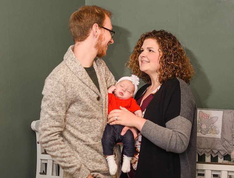 Daryl and Samantha Struemph pose with their newborn daughter, Esther, in their Jefferson City home.