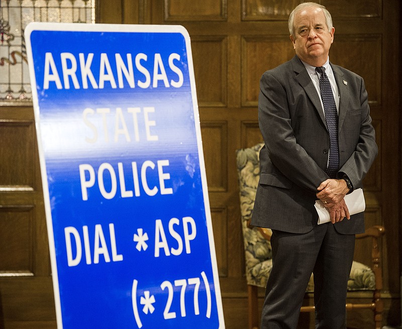 Colonel Bill Bryant, from the Arkansas Department of Public Safety, stands near a highway sign announcing a new non-emergency police number during an unveiling on Tuesday, Jan. 25, 2022. See more photos at arkansasonline.com/126gov/ (Arkansas Democrat-Gazette/Stephen Swofford)