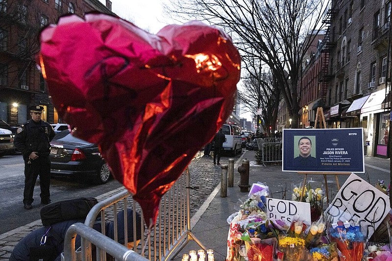 A makeshift memorial is seen outside the New York City Police Department's 32nd Precinct, near the scene of a shooting days earlier in the Harlem neighborhood of New York, Monday Jan. 24, 2022. (AP/Yuki Iwamura)