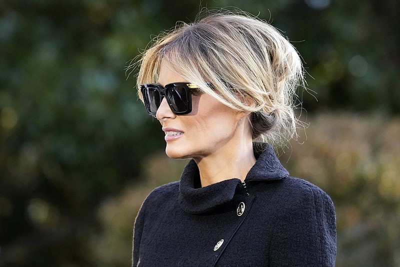 Former First Lady Melania Trump listens as President Donald Trump speaks with reporters as he walks to board Marine One on the South Lawn of the White House, Wednesday, Jan. 20, 2021, in Washington. The former first lady launched a venture this week selling non-fungible tokens that must be paid for with Solan cryptocurrency, currently valued around $180 each. 
(AP Photo/Alex Brandon, File)
