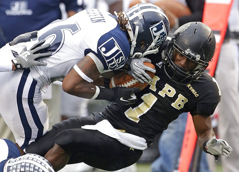 In this Dec. 8, 2012, file photo, Arkansas-Pine Bluff wide receiver Johnathan Johnson (1) is stopped by Jackson State linebacker Ryan Griffin (26) in the first half of an NCAA college game for the SWAC championship at Legion Field in Birmingham, Ala. (AP/Dave Martin)