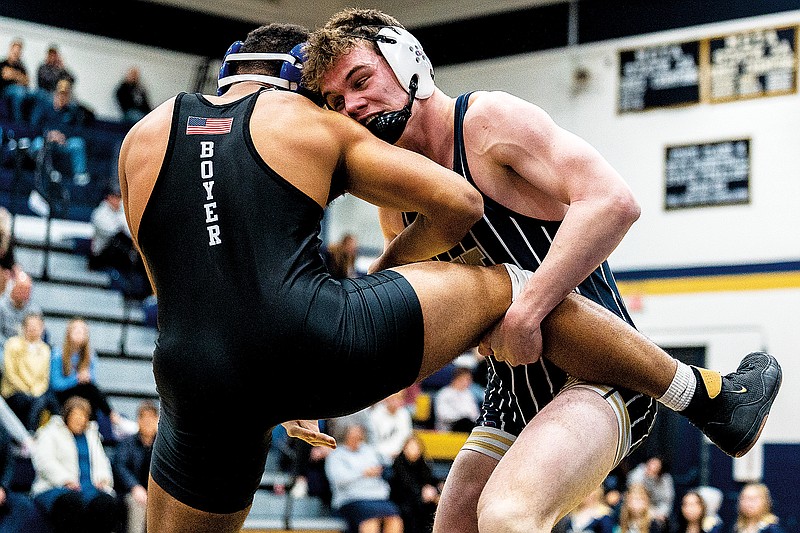 Connor Wilbers tries to take down Matt Boyer of Capital City during their 182-pound match Tuesday night at Rackers Fieldhouse. (Ethan Weston/News Tribune)