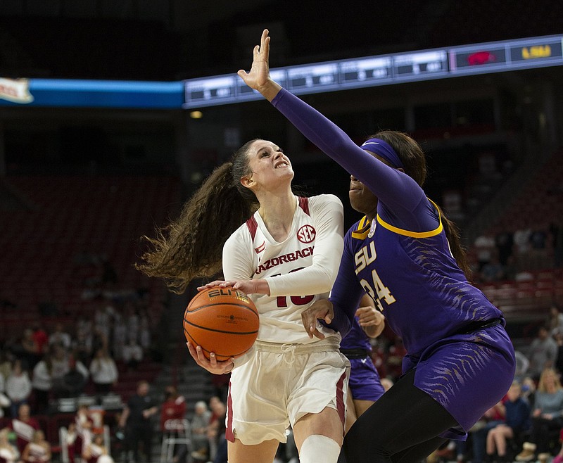 Arkansas sophomore Sasha Goforth (left) tries to put up a shot by being guarded by LSU’s Faustine Aifuwa during Thursday night’s game at Walton Arena in Fayetteville. More photos available at arkansasonline.com/128lsuua.
(Special to the NWA Democrat-Gazette/David Beach)