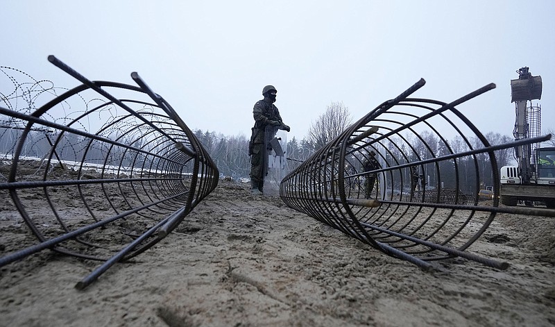 Work begins Thursday near Kuznica, Poland, on the first part of about 115 miles of an 18-foot-high metal wall intended to block migrants pushed out by Belarus. More photos at arkansasonline.com/128tolcze/.
(AP/Czarek Sokolowski)