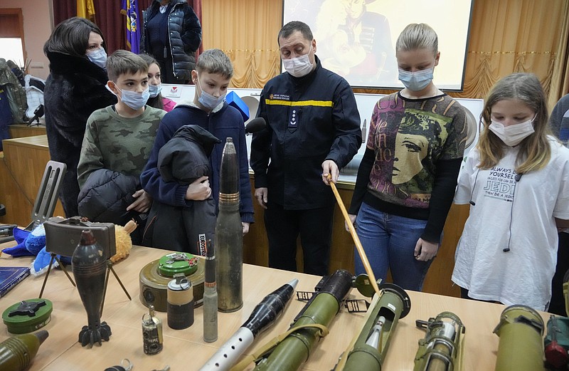 A police officer shows explosives to schoolchildren during a police-organized civilian safety lesson Thursday in a city school in Kyiv, Ukraine. More photos at arkansasonline.com/128luhansk/
(AP/Efrem Lukatsky)