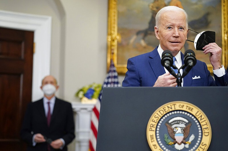 President Joe Biden removes his face mask as he prepares to deliver remarks on the retirement of Supreme Court Associate Justice Stephen Breyer, left, in the Roosevelt Room of the White House in Washington, Thursday, Jan. 27, 2022. (AP/Andrew Harnik)