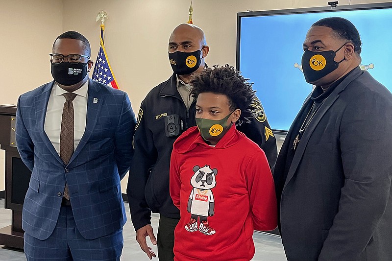 Raymond Long, (from left) CEO of Big Brothers Big Sisters of Central Arkansas; Pulaski County Sheriff’s Sgt. Willie Davis; sixth-grader Justin Henderson and Deputy Justin Johnson pose together Thursday at the sheriff’s office in Little Rock. Justin, who attends Mills Middle School, and Johnson are the first student and mentor in a new Bigs With Badges mentorship program offered by Big Brothers Big Sisters.
(Arkansas Democrat-Gazette/Grant Lancaster)