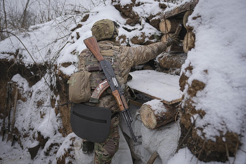 A Ukrainian soldier obscures an observation point damaged earlier by a mortar strike at a front-line position, about 100 yards from Russian separatists’ positions, in the Luhansk area of eastern Ukraine.
(AP/Vadim Ghirda)