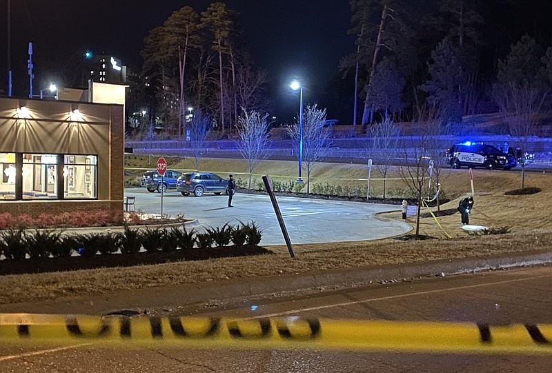 The Little Rock Police Department investigates a shooting next to the Raising Cane’s on University Avenue in Little Rock on Friday night, Jan. 28, 2022. (Arkansas Democrat-Gazette/Staci Vandagriff)