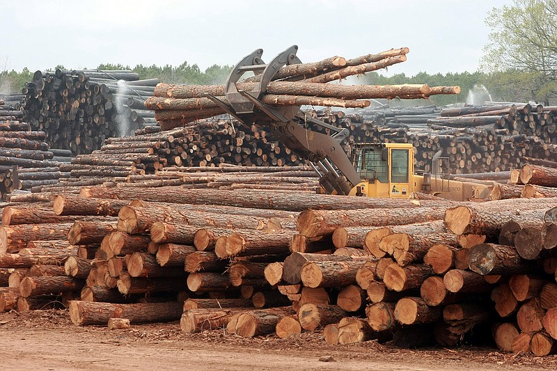 A large loader moves pine logs around at the Anthony Timberlands sawmill in Bearden.
(Democrat-Gazette file photo)