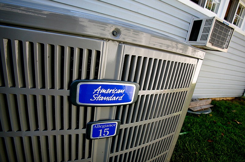 An American Standard Allegiance 15 air conditioning unit is hooked up and ready to replace the window air conditioning unit in this Aug. 8, 2008, file photo. (AP/Craig Ruttle)