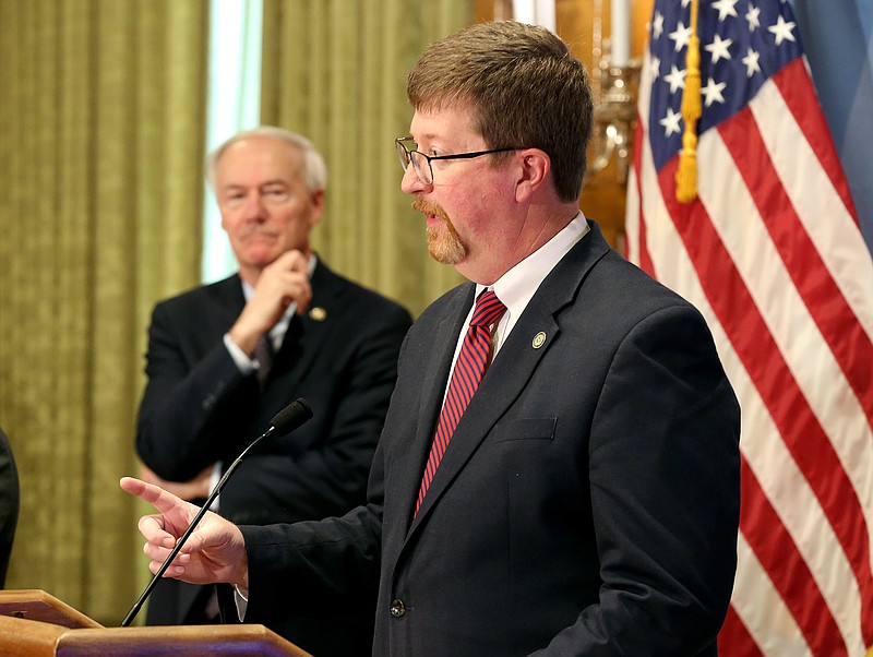 Secretary of Education Johnny Key (right) answers a question as Gov. Asa Hutchinson (center) listens during the weekly press briefing on Tuesday, Feb. 1, 2022, at the state Capitol in Little Rock. .(Arkansas Democrat-Gazette/Thomas Metthe)