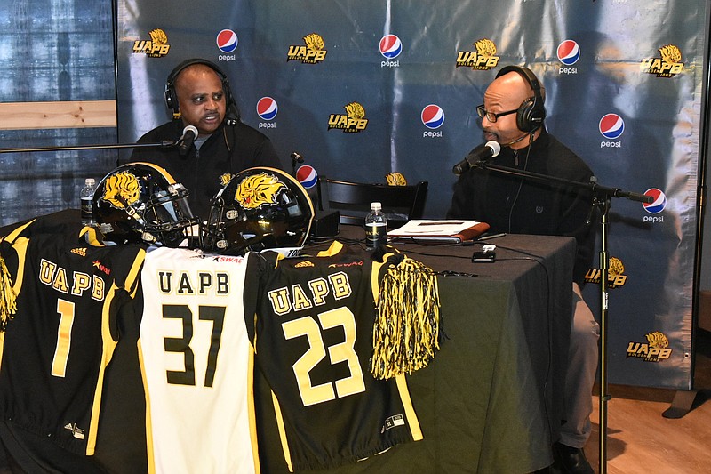 UAPB football Coach Doc Gamble, left, talks with radio host Laron Marbley during a live broadcast of UAPB’s National Signing Day event at Saracen Casino’s Legends Sports Bar on Wednesday. 
(Pine Bluff Commercial/I.C. Murrell)