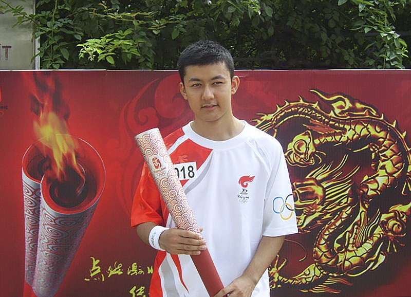 Kamalturk Yalqun holds the Olympic torch after running the torch relay for the 2008 Beijing Olympics in Qinhuangdao, China. Now an activist in the United States, he is calling for a boycott of the Winter Games over China’s treatment of his Uyghur ethnic community.
(Kamalturk Yalqun via AP)