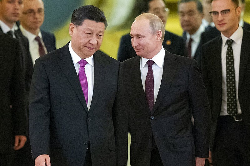 FILE - Chinese President Xi Jinping, center left, and Russian President Vladimir Putin, center right, enter a hall for talks in the Kremlin in Moscow, Russia, June 5, 2019. (AP/Alexander Zemlianichenko, Pool, File)