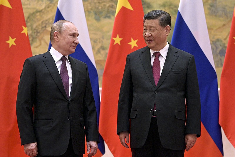 Chinese President Xi Jinping (right) and Russian President Vladimir Putin talk during their meeting Friday in Beijing. Video at arkansasonline.com/25alliance/.
(AP/Sputnik/Alexei Druzhinin)