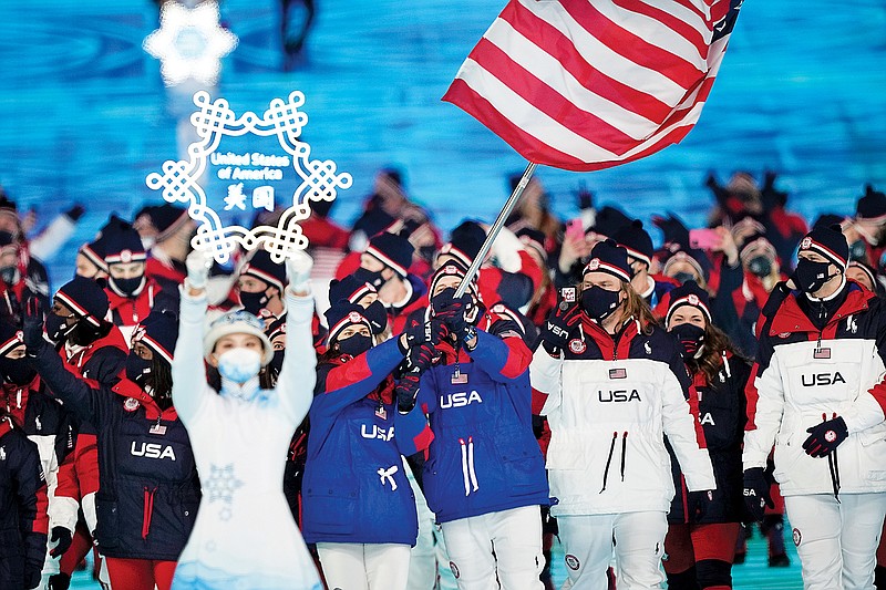 Brittany Bowe and John Shuster of the United States leads their team in during Friday's opening ceremony of the 2022 Winter Olympics in Beijing. (Associated Press)