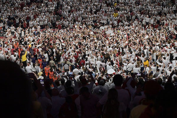 Fans are shown on the court following Arkansas' 80-76 win over Auburn on Tuesday, Feb. 8, 2022, in Fayetteville.