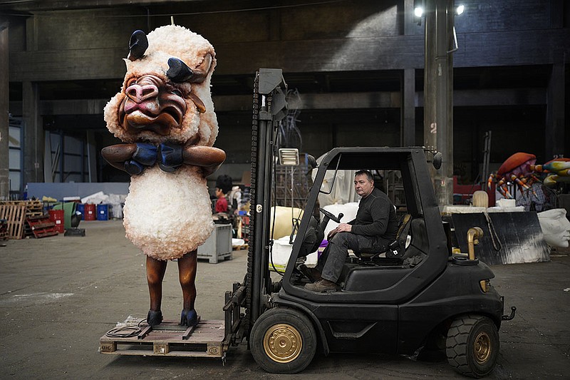 Artisan Pierre Povigna moves a carnival figure Thursday at a warehouse in Nice in southern France. The theme of the Carnival’s 149th edition, which begins today, is King of Animals. Organizers promise a loud celebration of nature, human connection and life itself after months of lockdowns, silence, social distancing and banned public gatherings.
(AP/Daniel Cole)