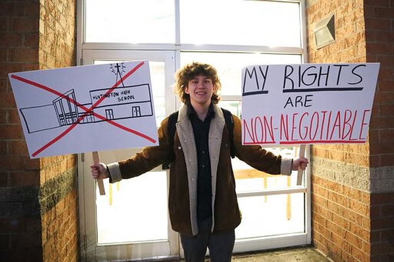 Huntington High School senior Max Nibert holds a sign he made prior to a protest in the West Virginia city. Nibert and some other students objected to being required to attend an evangelical Christian assembly at their school, arguing that it violates their constitutional rights.
(AP/Leah M. Willingham)