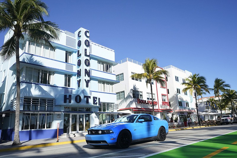 A car drives past Art Deco hotels, in late January, in Miami’s famed South Beach
(File Photo/AP/Wilfredo Lee)