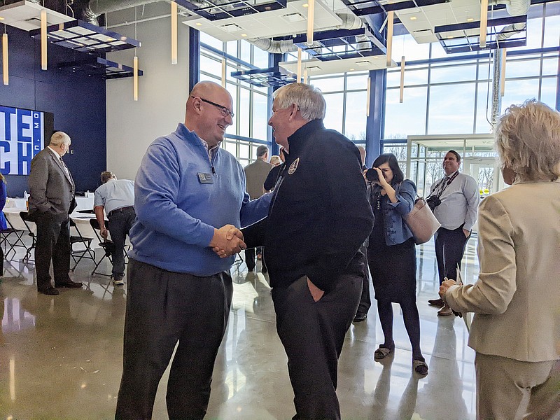 Chris Bowser, vice president of student affairs at State Technical College of Missouri, greeted Gov. Mike Parson on Tuesday morning at a roundtable event focused on workforce development. Parson said trade and technical schools will be crucial in his workforce development plans. (Ryan Pivoney/News Tribune)